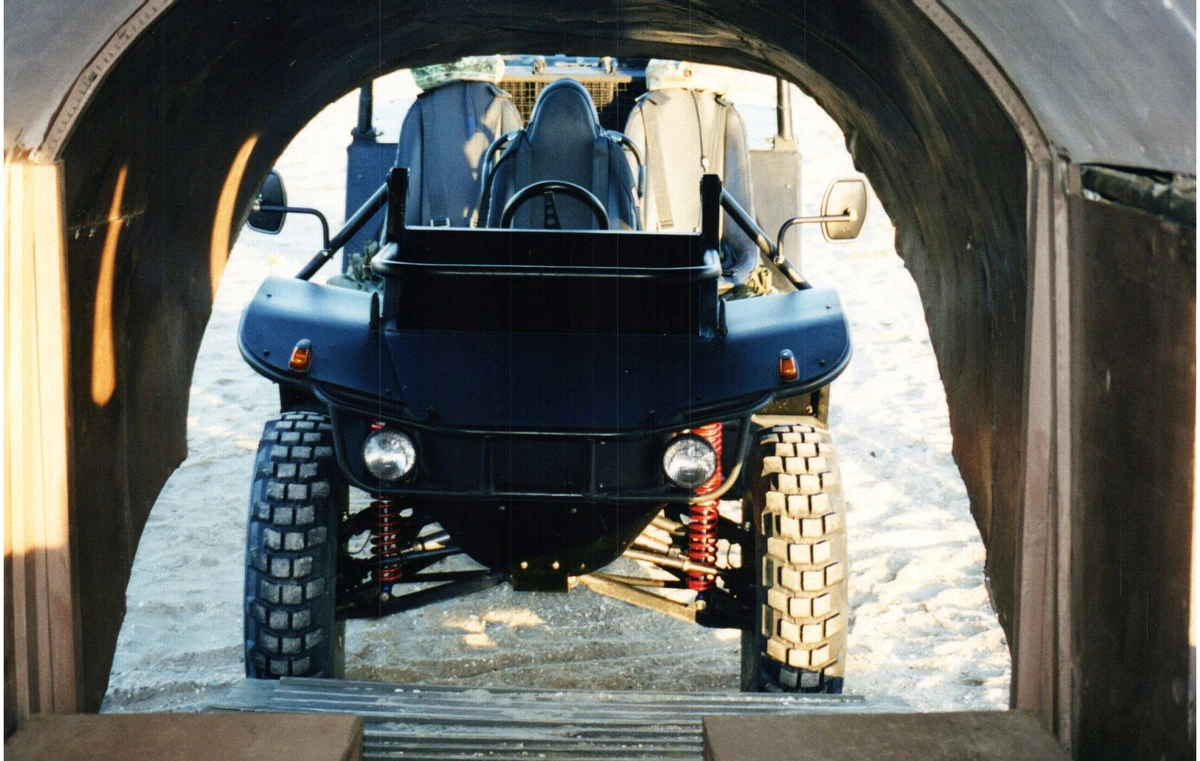 A Flyer vehicle viewed head-on through the open rear of an aircraft