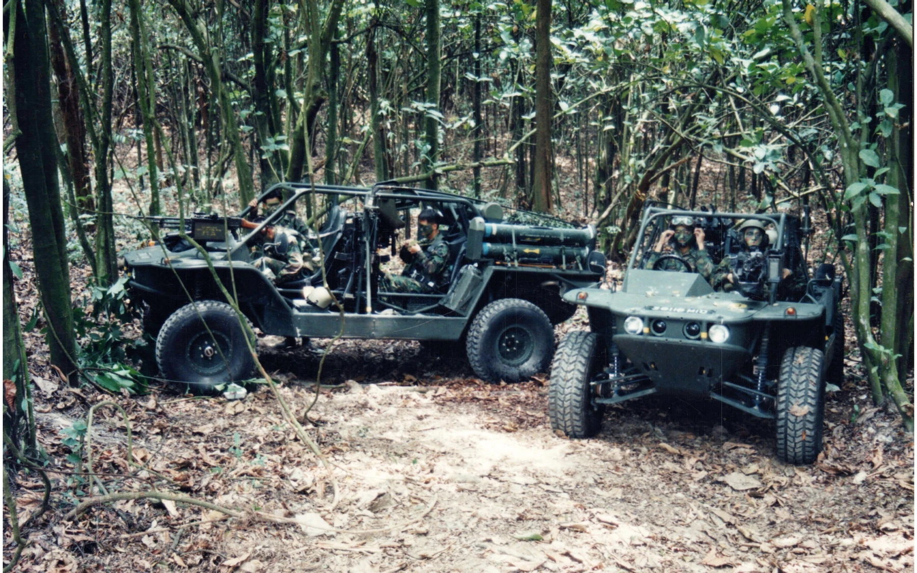 Two open-cab vehicles and their occupants in woodland